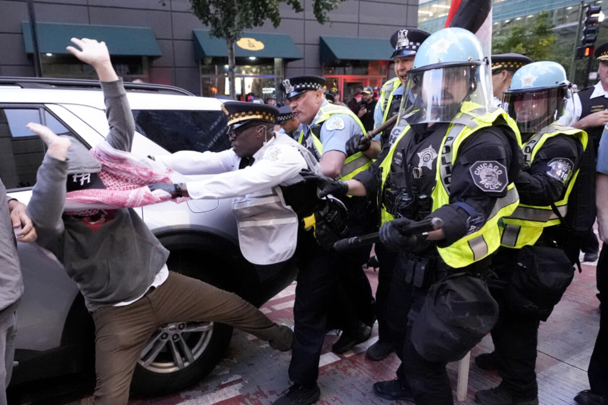 Demonstrators clash with police near the Israeli Consulate during the Democratic National Convention Tuesday, Aug. 20, 2024, in Chicago.