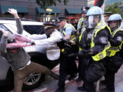 Demonstrators clash with police near the Israeli Consulate during the Democratic National Convention Tuesday, Aug. 20, 2024, in Chicago.