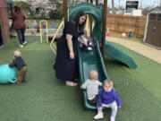 FILE - Delaney Griffin, center, plays with toddlers at the child care center where she works, March 13, 2024, in Lexington, Ky.