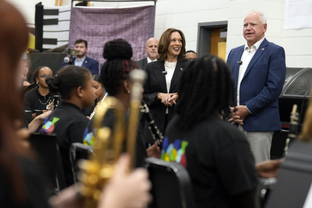 Democratic presidential nominee Vice President Kamala Harris and Democratic vice presidential candidate Minnesota Gov. Tim Walz speak to marching band members at Liberty County High School in Hinesville, Ga., Wednesday, Aug. 28, 2024.