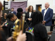 Democratic presidential nominee Vice President Kamala Harris and Democratic vice presidential candidate Minnesota Gov. Tim Walz speak to marching band members at Liberty County High School in Hinesville, Ga., Wednesday, Aug. 28, 2024.