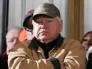 FILE - Minnesota Gov. Tim Walz listens as President Joe Biden speaks at Dutch Creek Farms in Northfield, Minn., Nov. 1, 2023.