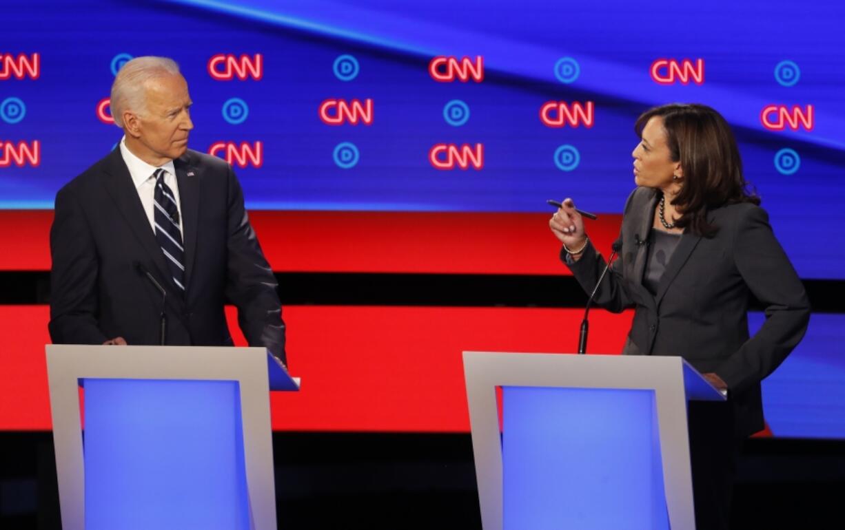 FILE - Former Vice President Joe Biden, left, listens as Sen. Kamala Harris, D-Calif., speaks during a Democratic presidential primary debates, July 31, 2019, in Detroit.