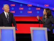 FILE - Former Vice President Joe Biden, left, listens as Sen. Kamala Harris, D-Calif., speaks during a Democratic presidential primary debates, July 31, 2019, in Detroit.