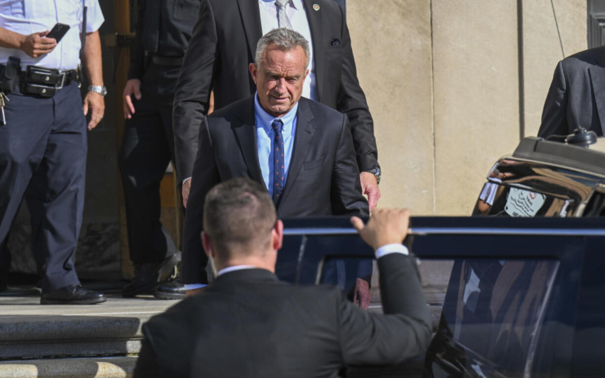 FILE - Independent presidential candidate Robert F. Kennedy Jr., top, leaves after giving testimony at the Albany County Courthouse, Aug. 7, 2024, in Albany, N.Y.