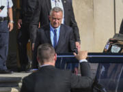 FILE - Independent presidential candidate Robert F. Kennedy Jr., top, leaves after giving testimony at the Albany County Courthouse, Aug. 7, 2024, in Albany, N.Y.