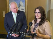 FILE - Minnesota Lt. Gov. Peggy Flanagan, right, and Gov. Tim Walz speak to reporters at the State Capitol in St. Paul, Minn., Monday, March 21, 2022.