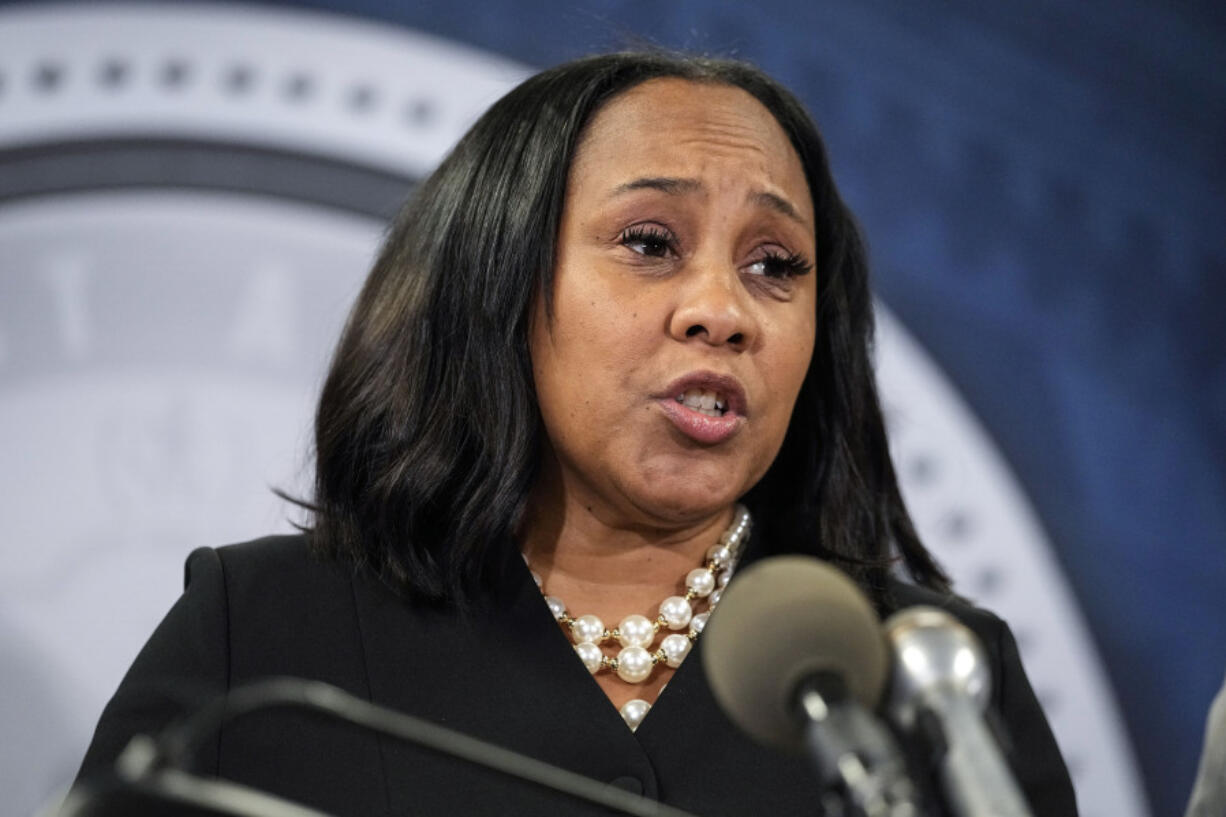 FILE - Fulton County District Attorney Fani Willis speaks during a news conference, Aug. 14, 2023, in Atlanta. People connected with former President Donald Trump&rsquo;s legal cases have been inundated with threats. In Atlanta, Willis, who brought criminal charges against Trump and 18 other people alleging they schemed to illegally overturn the 2020 election results in Georgia, is known to be accompanied by round-the-clock bodyguards.