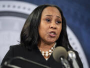 FILE - Fulton County District Attorney Fani Willis speaks during a news conference, Aug. 14, 2023, in Atlanta. People connected with former President Donald Trump&rsquo;s legal cases have been inundated with threats. In Atlanta, Willis, who brought criminal charges against Trump and 18 other people alleging they schemed to illegally overturn the 2020 election results in Georgia, is known to be accompanied by round-the-clock bodyguards.