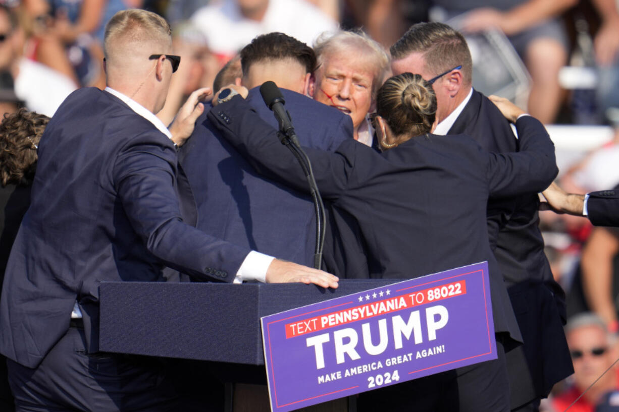 FILE - Republican presidential candidate former President Donald Trump is surrounded by Secret Service at a campaign event in Butler, Pa., July 13, 2024. Few Americans have high confidence in the Secret Service&rsquo;s ability to keep presidential candidates safe after last month&rsquo;s attempt on Trump&rsquo;s life. That is according to a new poll conducted July 25-29, 2024, from the AP-NORC Center for Public Affairs Research. Only around three in 10 Americans are extremely or very confident that the Secret Service can keep the presidential candidates safe from violence before the election. (AP Photo/Gene J.