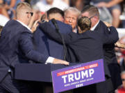 FILE - Republican presidential candidate former President Donald Trump is surrounded by Secret Service at a campaign event in Butler, Pa., July 13, 2024. Few Americans have high confidence in the Secret Service&rsquo;s ability to keep presidential candidates safe after last month&rsquo;s attempt on Trump&rsquo;s life. That is according to a new poll conducted July 25-29, 2024, from the AP-NORC Center for Public Affairs Research. Only around three in 10 Americans are extremely or very confident that the Secret Service can keep the presidential candidates safe from violence before the election. (AP Photo/Gene J.