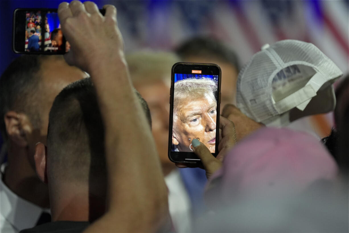 Republican presidential nominee former President Donald Trump greets supporters at a town hall with former Democratic Rep. Tulsi Gabbard, Thursday, Aug. 29, 2024, in La Crosse, Wis.