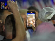 Republican presidential nominee former President Donald Trump greets supporters at a town hall with former Democratic Rep. Tulsi Gabbard, Thursday, Aug. 29, 2024, in La Crosse, Wis.