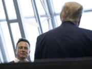 FILE - Tesla and SpaceX CEO Elon Musk talks with President Donald Trump, May 30, 2020, in Cape Canaveral, Fla.