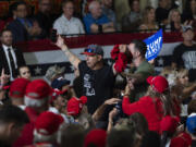 A heckler wearing a T-shirt bearing the name of Vice President Kamala Harris is escorted off a campaign event with Republican vice presidential candidate Sen. JD Vance, R-Ohio, in Glendale, Ariz., Wednesday, July 31, 2024. (AP Photo/Jae C.