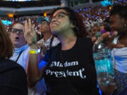 Monique LaFonta, of Milwaukee, dances while watching the roll call of the DNC on a jumbotron ahead of a speech by Democratic presidential nominee Vice President Kamala Harris at the Fiserv Forum during a campaign rally in Milwaukee, Tuesday, Aug. 20, 2024.