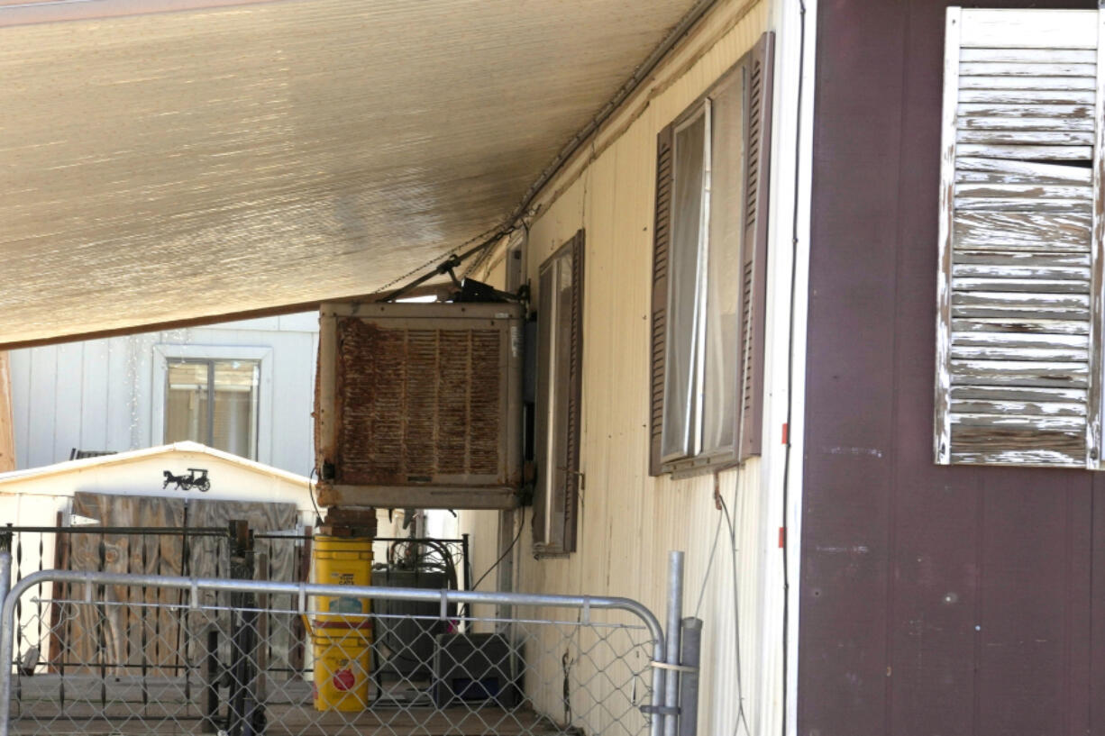 The mobile home where Shirley Kouplen lived shown Thursday, May 23, 2024, in Phoenix. Her mobile home cooling system stopped working during the sweltering heatwave of 2023, and by the time emergency responders arrived, the 70-year-old widow&rsquo;s temperature was 107.1 degrees, was diagnosed with heat stroke, suffered several heart attacks and later died at a local hospital. (AP Photo/Ross D.