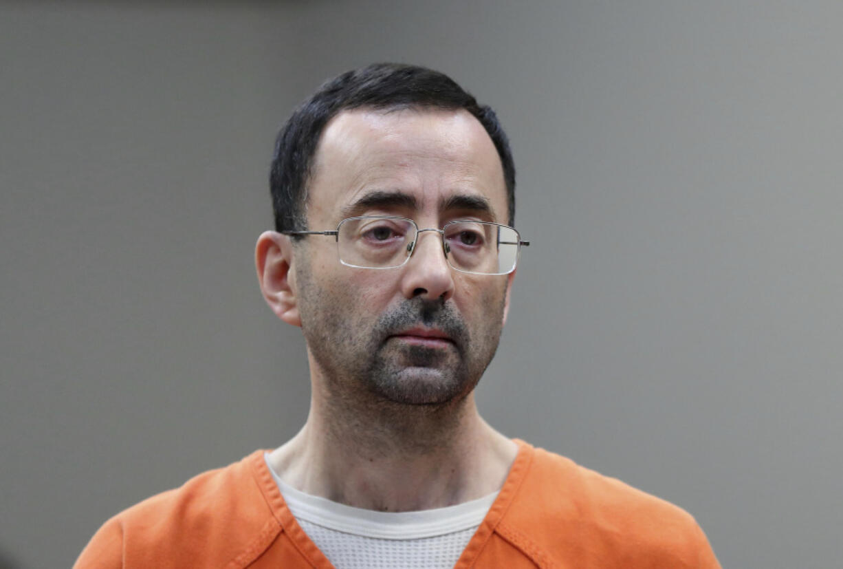 FILE - Disgraced former sports doctor Larry Nassar appears in court for a plea hearing, Nov. 22, 2017, in Lansing, Mich.