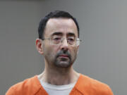 FILE - Disgraced former sports doctor Larry Nassar appears in court for a plea hearing, Nov. 22, 2017, in Lansing, Mich.