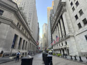 The New York Stock Exchange, at right, is shown on Wednesday, Aug. 14, 2024, in New York.