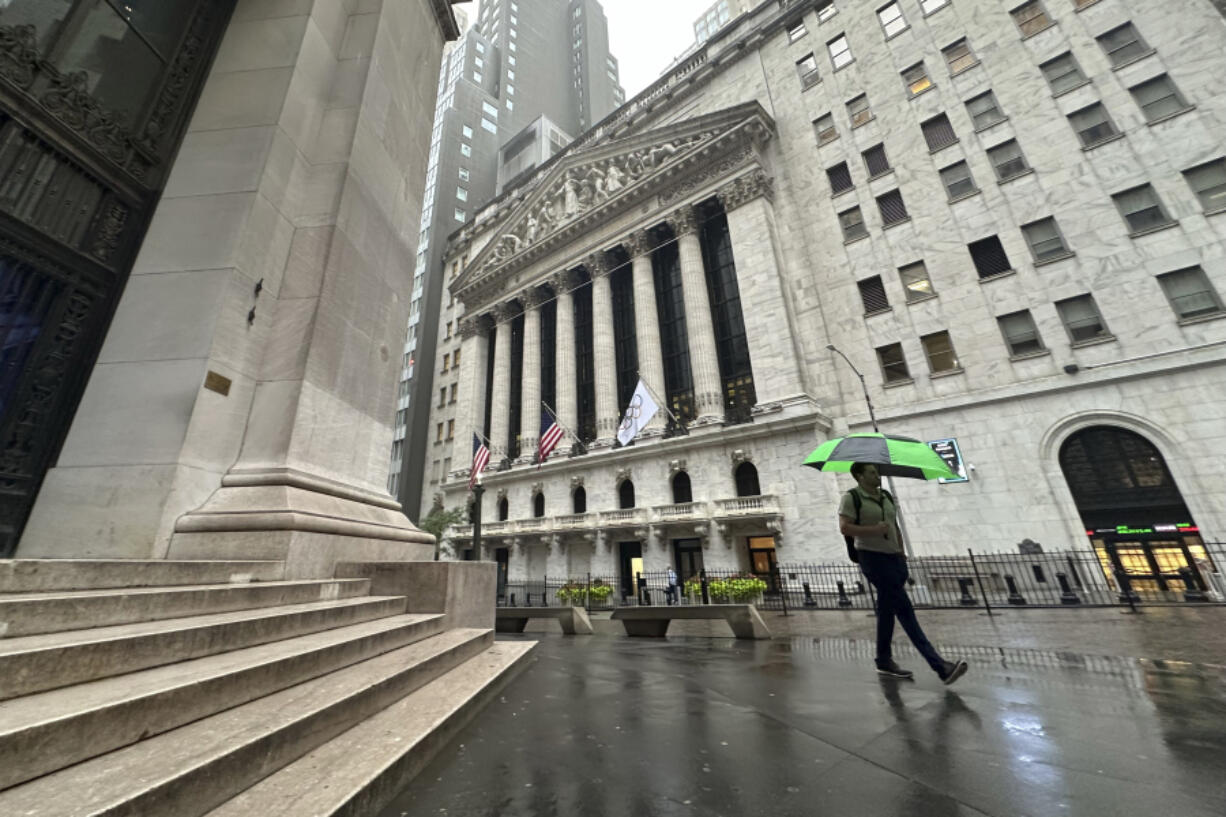 FILE - A man walks past the New York Stock Exchange on Wednesday, Aug. 7, 2024 in New York.