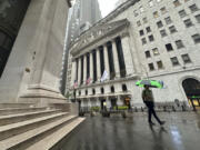 FILE - A man walks past the New York Stock Exchange on Wednesday, Aug. 7, 2024 in New York.