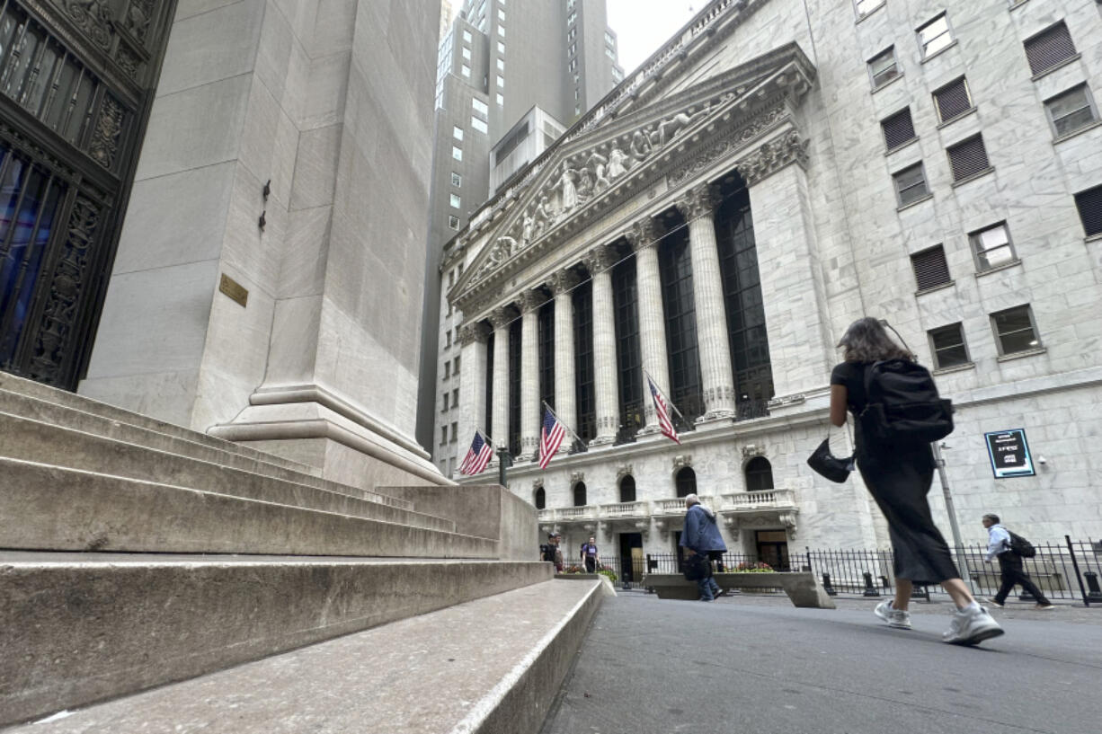 Pedestrians pass the New York Stock Exchange, on Tuesday, Aug. 20, 2024, in New York.