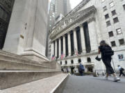 Pedestrians pass the New York Stock Exchange, on Tuesday, Aug. 20, 2024, in New York.