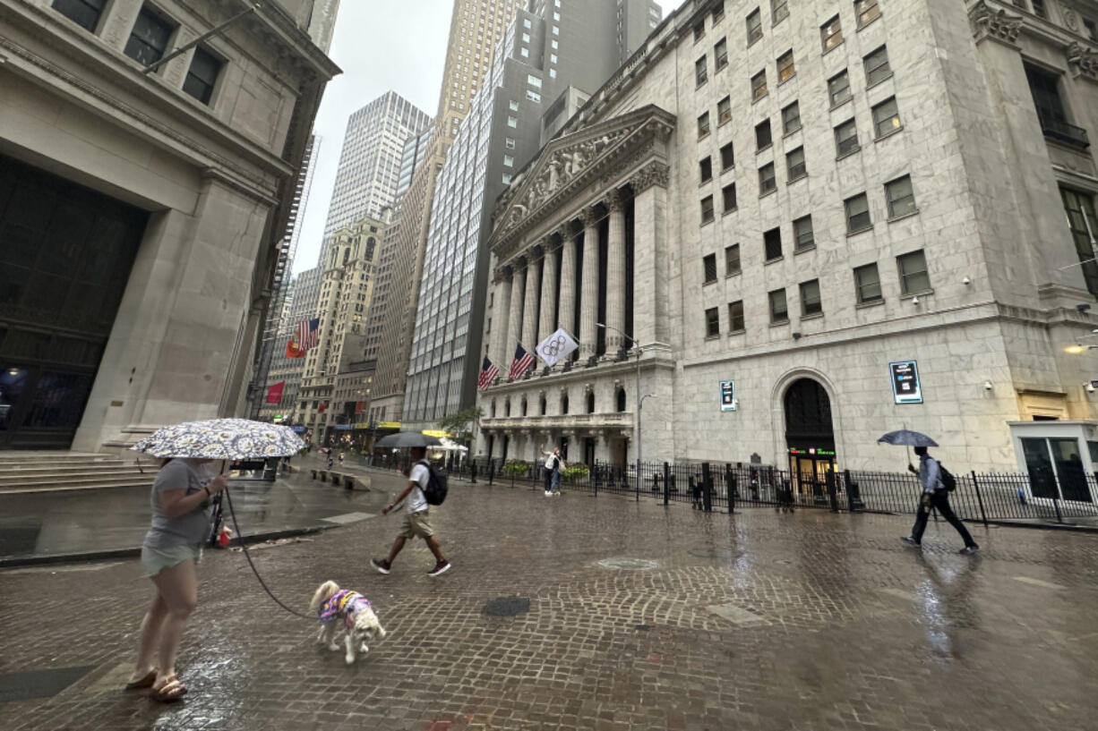 FILE - People walk past the New York Stock Exchange on Aug. 7, 2024 in New York.