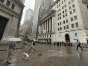 FILE - People walk past the New York Stock Exchange on Aug. 7, 2024 in New York.