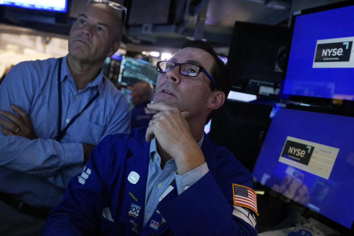 FILE - Specialist John McNierney, right, works with a colleague on the floor of the New York Stock Exchange, Aug. 7, 2024.