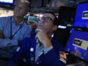 FILE - Specialist John McNierney, right, works with a colleague on the floor of the New York Stock Exchange, Aug. 7, 2024.