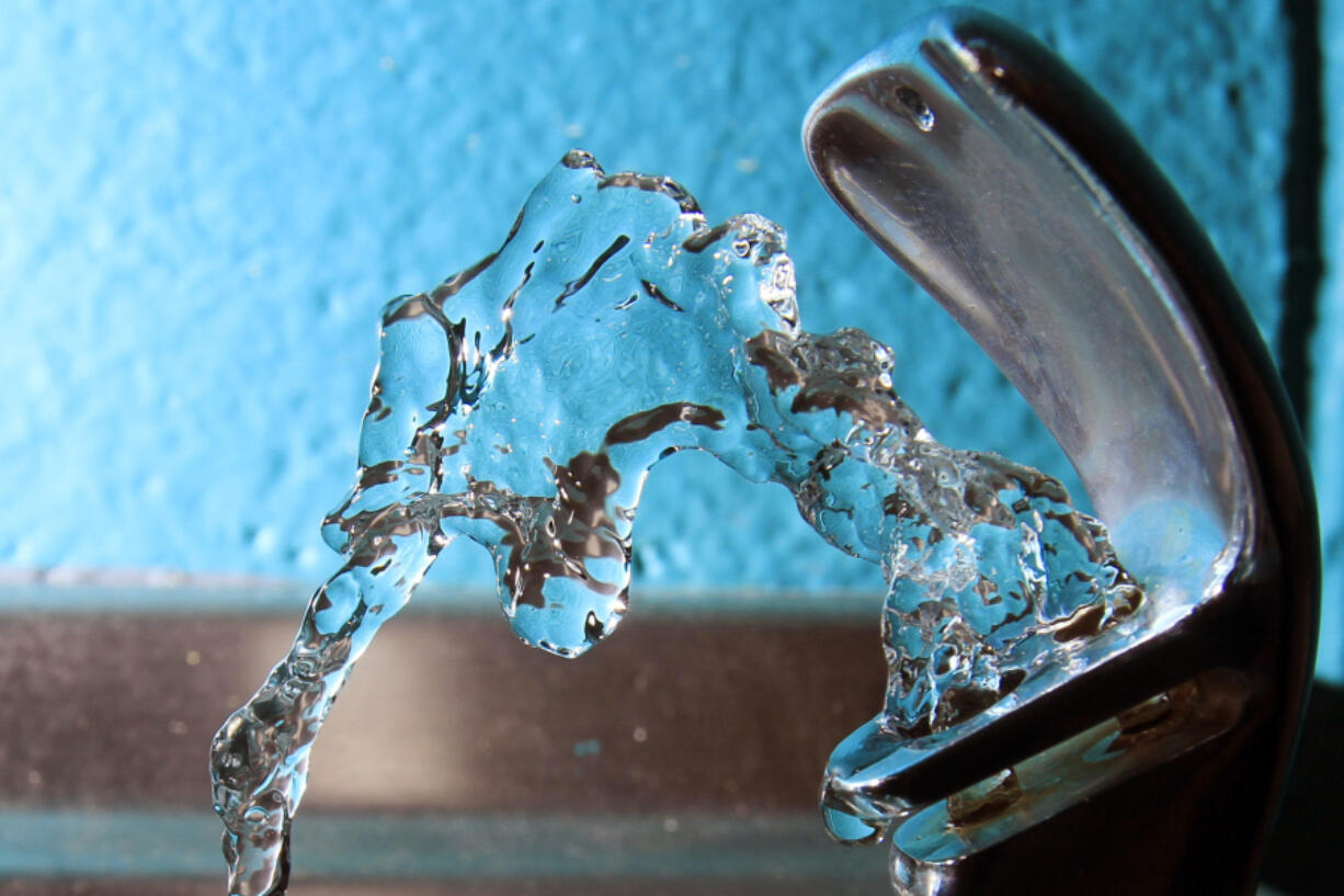 FILE - Water flows from a water fountain in Concord, N.H., on Friday, Jan. 7, 2011.