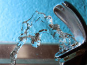 FILE - Water flows from a water fountain in Concord, N.H., on Friday, Jan. 7, 2011.