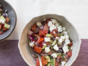 Traditional Greek salad with fresh cucumbers, tomatoes, feta, onion, and olives.