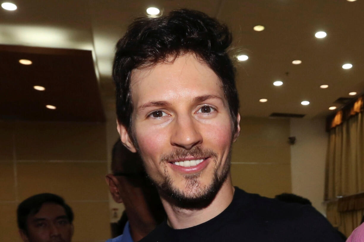 FILE - Telegram co-founder Pavel Durov, center, smiles following his meeting with Indonesian Communication and Information Minister Rudiantara in Jakarta, Indonesia on Aug. 1, 2017.