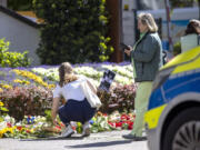 Flowers and candles are placed in Solingen, Germany, Sunday, Aug. 25, 2024, near the scene of Friday&#039;s deadly attack.