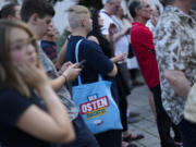 A young man with a bag reading &ldquo;The east does it&rdquo; attends an election campaign rally of the far-right Alternative for Germany, AfD, party in Suhl, Germany, Tuesday, Aug. 13, 2024.