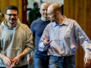 Freed Russian prisoners Ilya Yashin, from left, Andrei Pivovarov and Vladimir Kara-Murza, approach a press conference in Bonn, Germany, Friday, Aug. 2, 2024, a day after they were released as part of a 24-person prisoner swap between Russia and the United States.