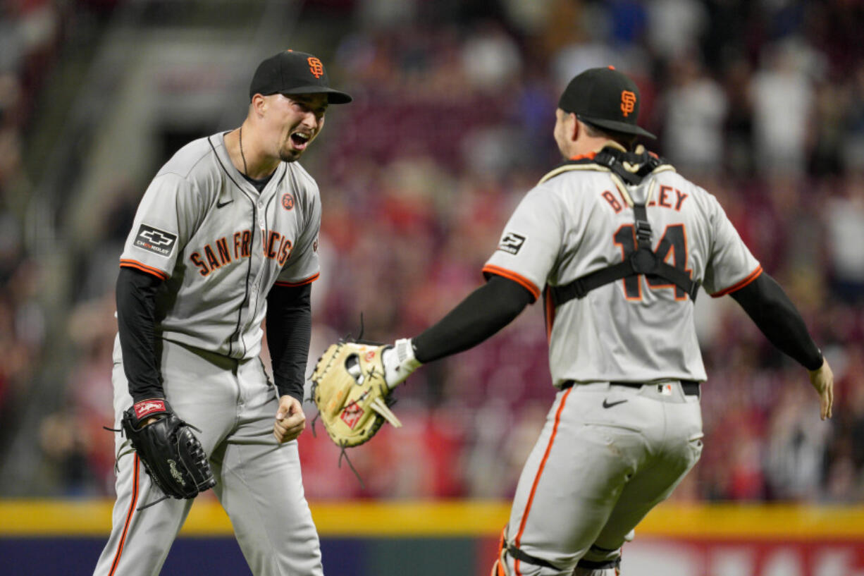 San Francisco Giants pitcher Blake Snell, left, celebrates with teammate Patrick Bailey (14) after throwing a no-hitter in nine complete innings of a baseball game against the Cincinnati Reds, Friday, Aug. 2, 2024, in Cincinnati.