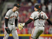 San Francisco Giants pitcher Blake Snell, left, celebrates with teammate Patrick Bailey (14) after throwing a no-hitter in nine complete innings of a baseball game against the Cincinnati Reds, Friday, Aug. 2, 2024, in Cincinnati.