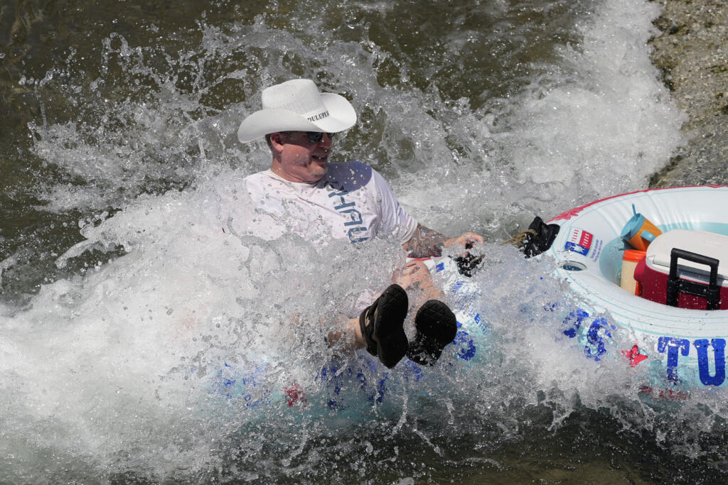 A tuber floats the cool Comal River as temperatures in South Texas hit triple-digit numbers, Wednesday, Aug. 21, 2024, in New Braunfels, Texas.