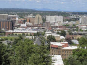 FILE - The downtown skyline is shown from the South Hill in Spokane, Wash., on June 4, 2018. The American Civil Liberties Union of Washington has sued the city of Spokane, alleging that its anti-homeless laws violate the state constitution. The group filed the suit on Thursday, Aug. 1, 2024, on behalf of a currently homeless person and someone who was formerly homeless. (AP Photo/Nicholas K.