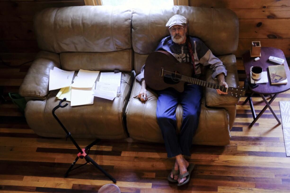 The Rev. Ron Blakely takes a break from rehearsing with sheet music and scripture for his Sunday Gospel Hour at Robert&rsquo;s Western World honky tonk on Friday, July 26, 2024, at his log cabin home near Watertown, Tenn.