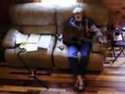 The Rev. Ron Blakely takes a break from rehearsing with sheet music and scripture for his Sunday Gospel Hour at Robert&rsquo;s Western World honky tonk on Friday, July 26, 2024, at his log cabin home near Watertown, Tenn.