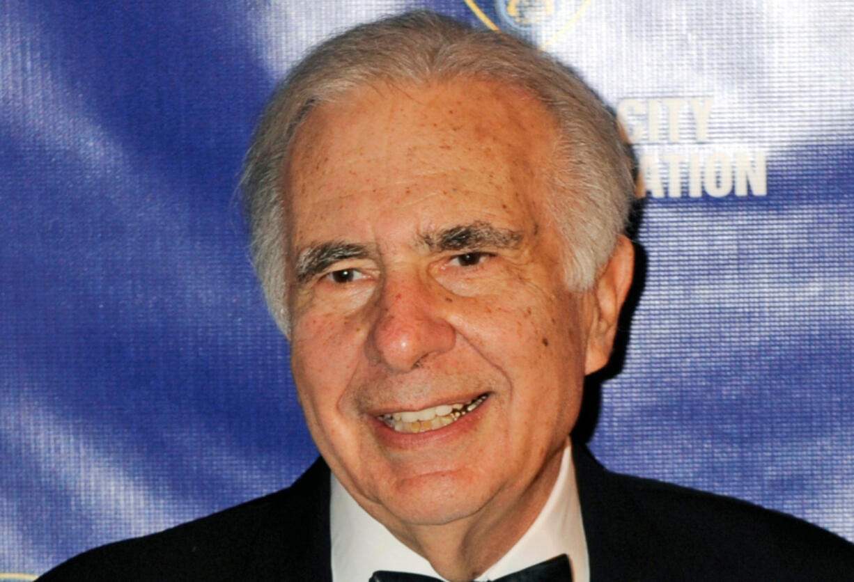 FILE - Financier Carl Icahn poses for photos upon arriving for the annual New York City Police Foundation Gala in New York, March 16, 2010.