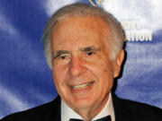 FILE - Financier Carl Icahn poses for photos upon arriving for the annual New York City Police Foundation Gala in New York, March 16, 2010.