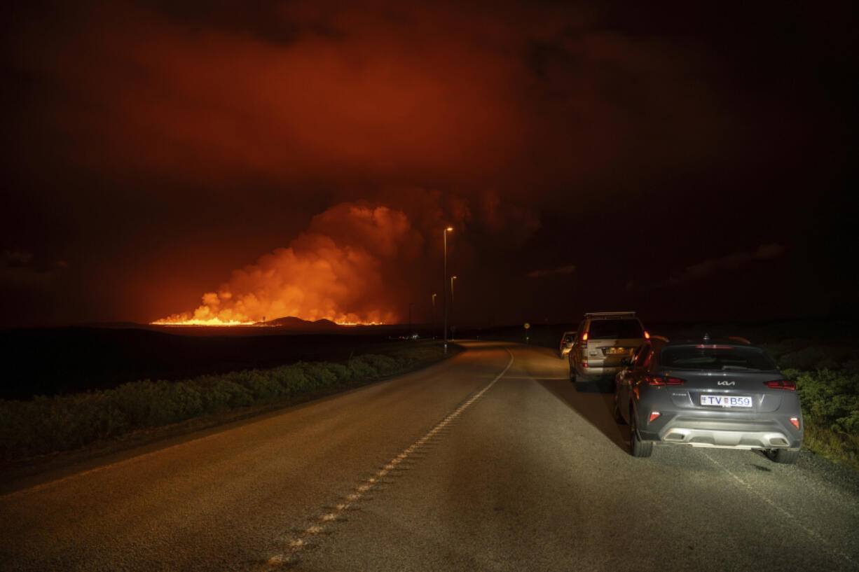 A new volcanic eruption is seen from the intersection between Reykjanesbraut, Iceland, and the road to Grindavik, Thursday, Aug. 22, 2024.