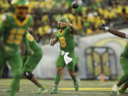 Oregon quarterback Dillon Gabriel, center, throws a pass during the first half of an NCAA college football game against Idaho, Saturday, Aug. 31, 2024, in Eugene, Ore.