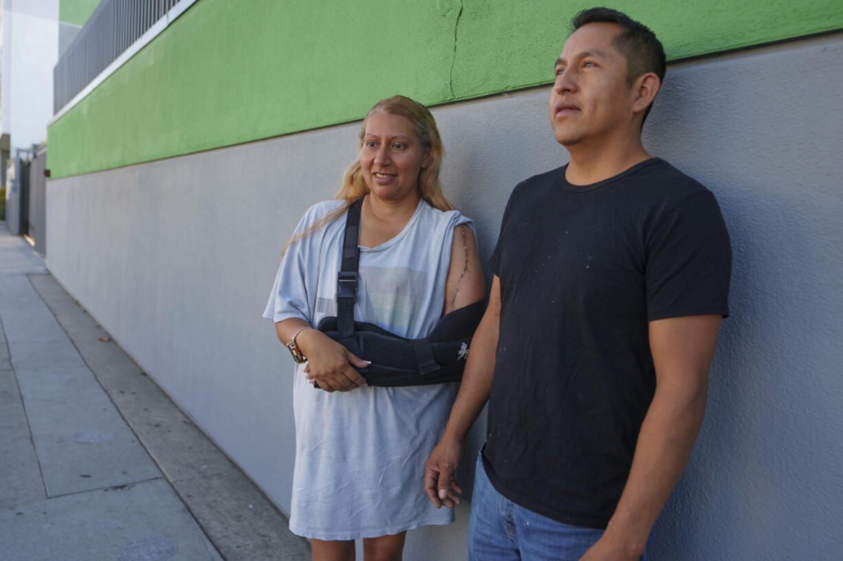 Roberto Garcia and his wife Maria Garcia pause for a picture after dropping their two children off for their first day of school in East Los Angeles on Wednesday, Aug. 14, 2024.